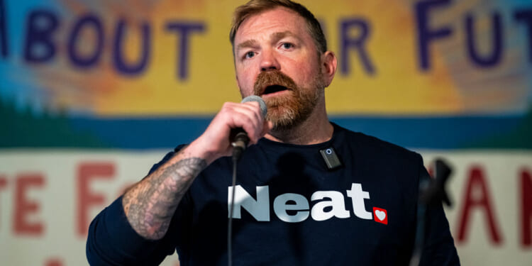 Graham Platner speaks at a rally.