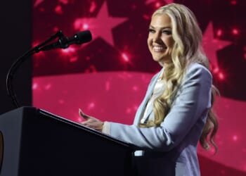 Erika Kirk speaking at a podium