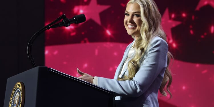 Erika Kirk speaking at a podium