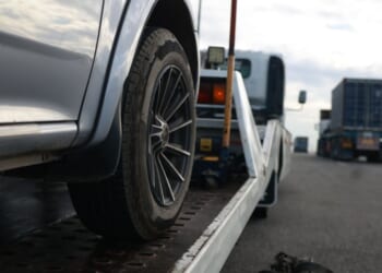 A car is loaded onto a tow truck.