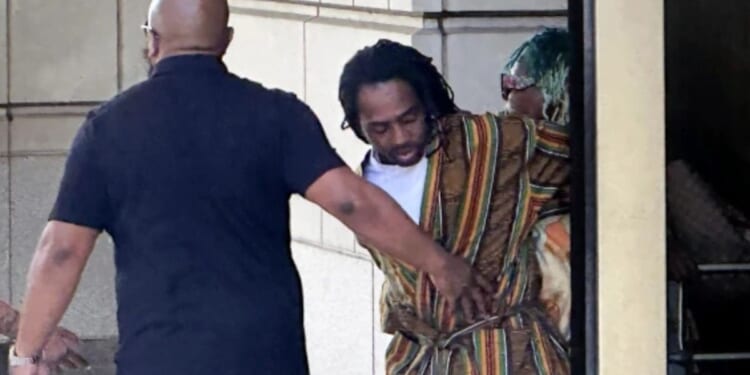 DC Councilman Trayon White Sr. is escorted out of the federal courthouse on August 19, 2024.