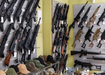 Guns are displayed on a shop’s wall.