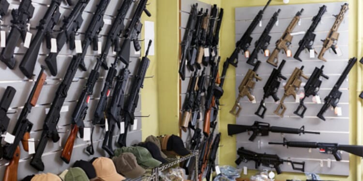 Guns are displayed on a shop’s wall.