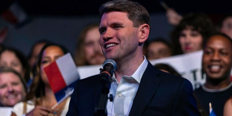 James Talarico stands among a cheering crowd on a campaign stop to Austin, Texas on March 3, 2026.