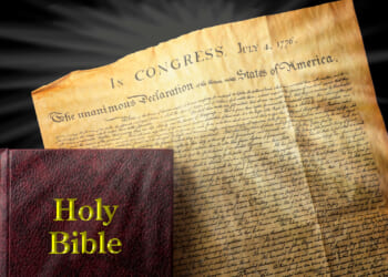 The Bible rests on a copy of the Declaration of Independence