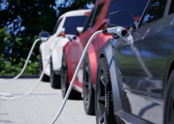 Generic electric cars charging on a city street.