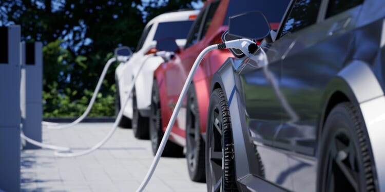 Generic electric cars charging on a city street.
