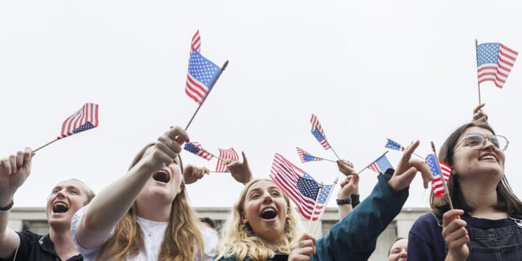 Parade attendees holding American Flags