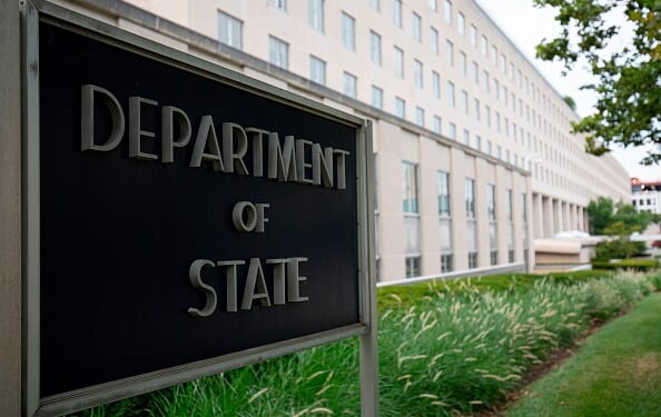 The Department of State sign stands outside the State Department Building in Washington, D.C. on July 22, 2019.