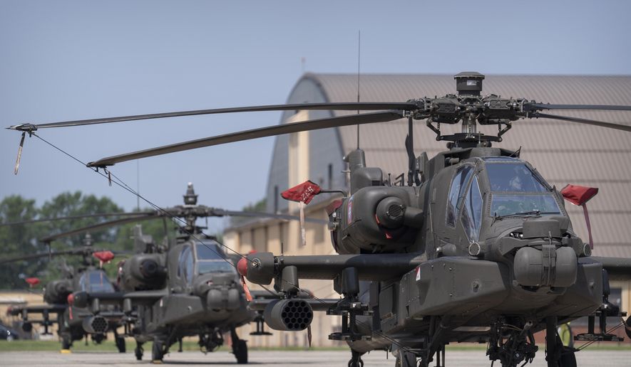 U.S. Army AH-64E Apache helicopters are pictured at Joint Base Andrews, Md., June 12, 2025. (AP Photo/Mark Schiefelbein, File)