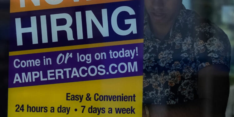 A hiring sign is displayed at a restaurant in Niles, Illinois, on May 14, 2026.