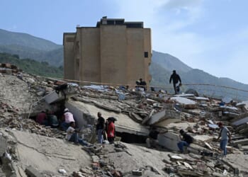 Volunteers search for possible victims amid the rubble following a twin earthquake in Caraballeda, La Guaira state, about 40 km northeast of Caracas, on June 25, 2026.