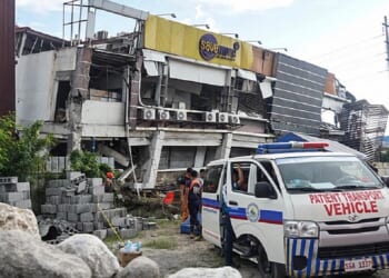 Responders conduct a rescue operation at a collapsed building after a 7.8 magnitude earthquake struck off the southern coast of the Philippines on Monday.