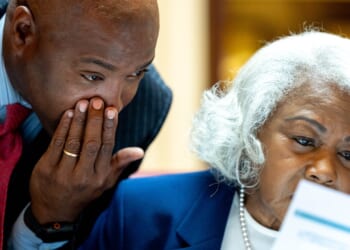 Virginia Sen. Aaron Rouse whispers to Sen. Louise Lucas in the Senate.