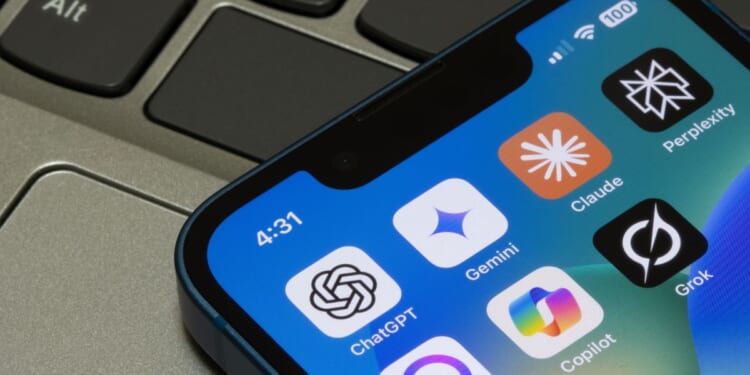 Assorted AI apps, including ChatGPT, Gemini, Claude, Perplexity, Meta AI, Microsoft Copilot, and Grok, are seen on the screen of an iPhone in Portland, Oregon, on May 2, 2025.