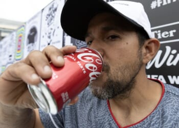 A man drinking soda