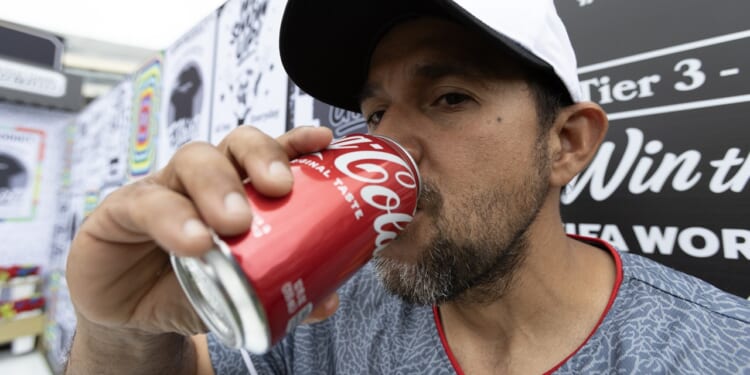 A man drinking soda