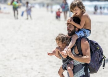 A dad and his two kids on the beach