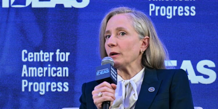 Virginia Governor Abigail Spanberger speaks into a microphone on stage, with a blue backdrop displaying Center for American Progress.