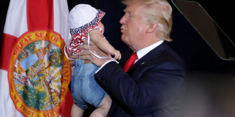 Donald Trump holding a baby