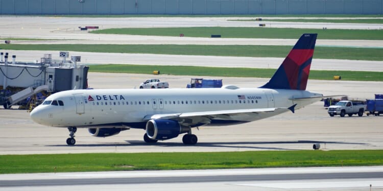 A Delta Air Lines plane taxies on the runway after landing at Chicago Midway International Airport on Aug. 2, 2023.