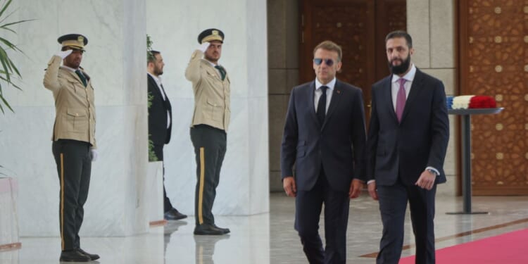 Explosions rock Damascus, wounding 18, as French President Macron visits Syria
