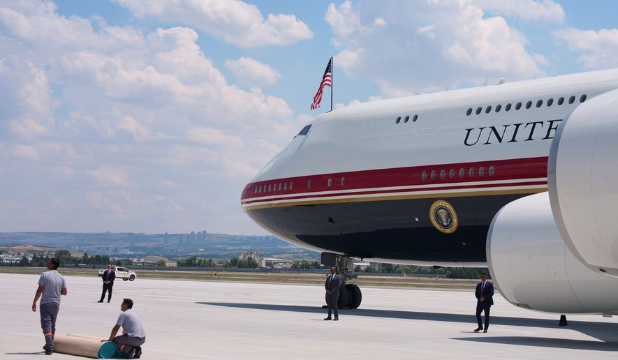 Staff lay a carpet on the tarmac before President Donald Trump exits Air Force One upon arriving for the NATO summit in Ankara, Turkey, Tuesday, July 7, 2026. (AP Photo/Alex Brandon)