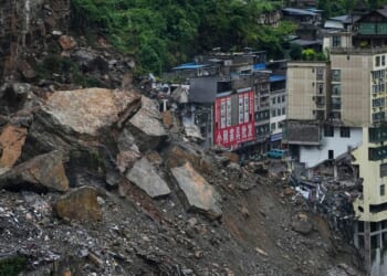 Rescuers race to find survivors in the rain after a landslide in China kills at least 8