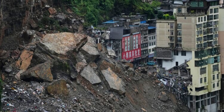Rescuers race to find survivors in the rain after a landslide in China kills at least 8