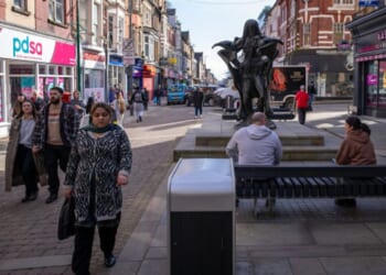 People walk along the square in Newport, Wales on March 2, 2026.