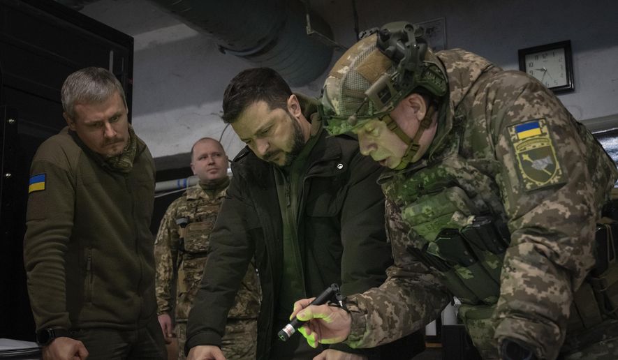 Ukrainian President Volodymyr Zelenskyy and Commander of Ukraine's Ground Forces Col.-Gen. Oleksandr Syrski, right, look at a map during their visit to the front-line city of Kupiansk, Kharkiv region, Ukraine, on Nov. 30, 2023. (AP Photo/Efrem Lukatsky, File)