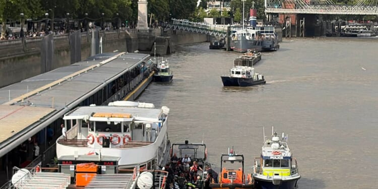 Police boat crashes into bridge in central London, sending officers into the Thames