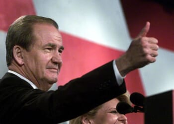 Reform Party presidential candidate Pat Buchanan, flanked by his wife Shelly, gives the thumbs-up to supporters after his Aug. 12, 2000, speech at the Reform Party National Convention in Long Beach, California.