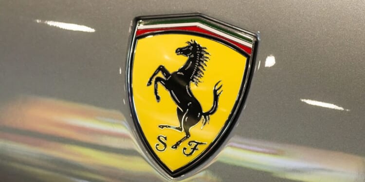 A Ferrari shield emblem is displayed on a vehicle during a June 3 auto show in Shenzhen, Guangdong Province, China.