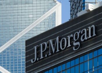The JPMorgan sign is displayed on an office building with the Bank of China Tower in the background on June 21, 2026, in Hong Kong, China.