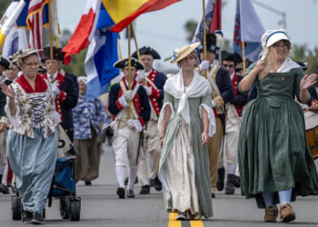 Daughters of the American Revolution and Sons of the American Revolution take part in a Fourth of July parade.