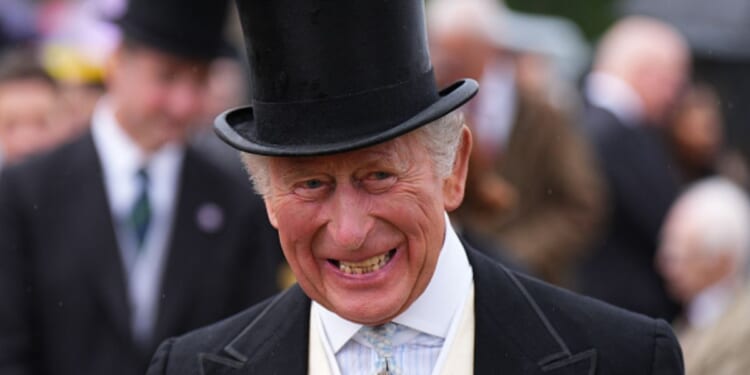King Charles III is pictured smiling during a garden party at the Palace of Holyroodhouse on June 30, 2026.
