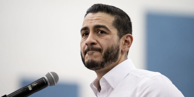 Close up of Abdul El-Sayed in a white shirt with open collar.