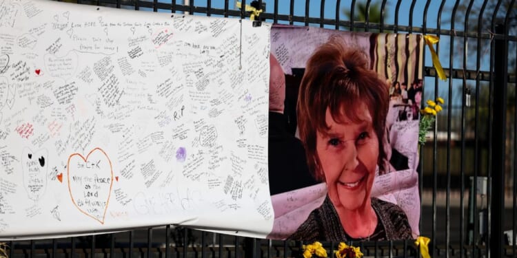 A photograph of Nancy Guthrie is seen on a sign that people can leave messages on Feb. 26, 2026, in Tucson, Arizona.