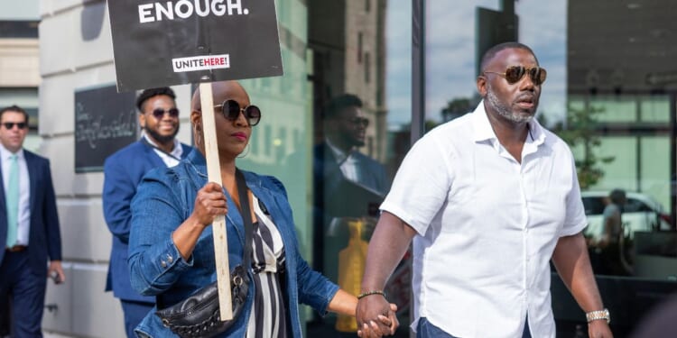 Rep. Ayanna Pressley and her husband, Conan Harris, join picketing hotel workers at the Boston Park Plaza Hotel on Sept. 2, 2024, in Boston, Massachusetts.