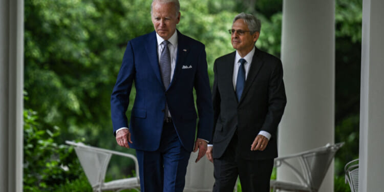Then President Joe Biden (L) and then-Attorney General Merrick Garland (R) walk into the Rose Garden from the Oval Office for an event on May 13, 2022. (Brendan Smialowski/AFP via Getty Images)