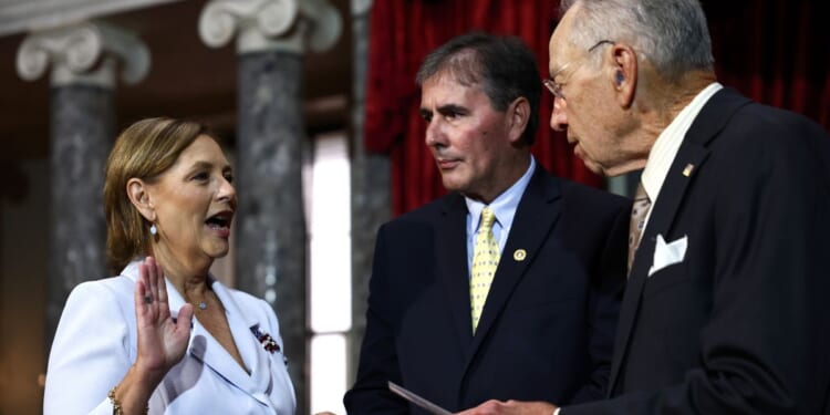 Sen. Darline Graham Nordone participates in a ceremonial swearing-in with Sen. Chuck Grassley as her husband Larry Nordone looks on in the Old Senate Chamber at the U.S. Capitol on July 14, 2026, in Washington, D.C.