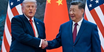 Donald Trump (R) shakes hands with China's President Xi Jinping