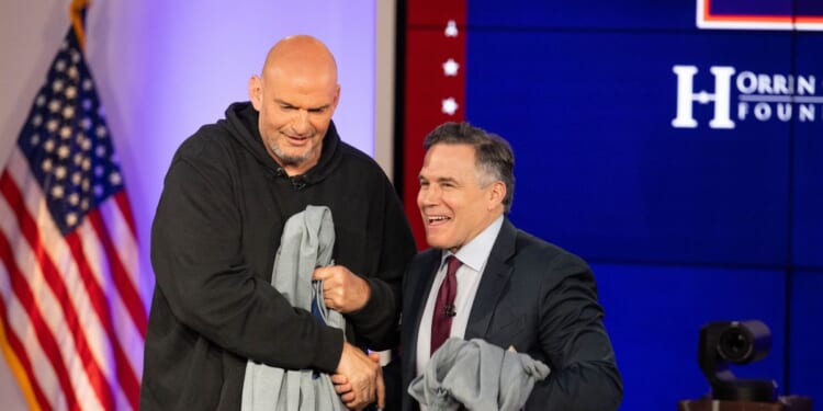 Sens. John Fetterman and David McCormick shake hands after the sixth installment of The Senate Project moderated by Fox News anchor Shannon Bream at the Edward M. Kennedy Institute for the United States Senate on June 2, 2025, in Boston, Massachusetts.