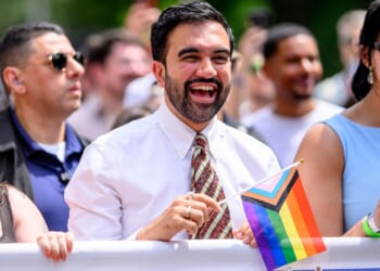 New York City Mayor Zohran Mamdani holding an LGBT flag