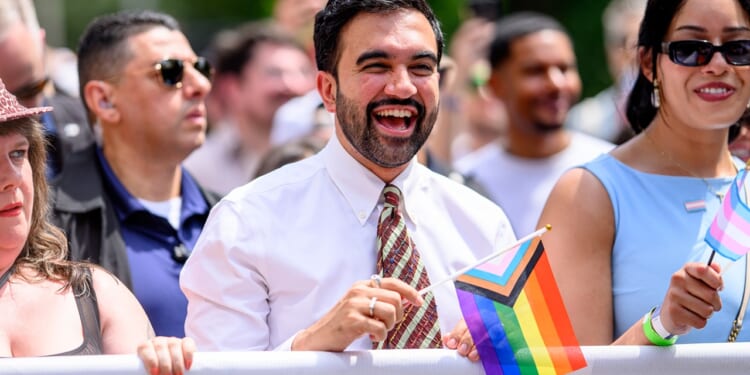 New York City Mayor Zohran Mamdani holding an LGBT flag