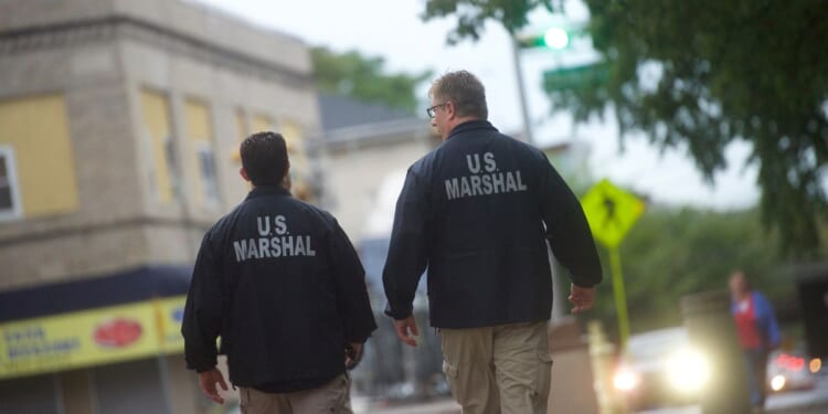 U.S. Marshals monitor activity outside the Martin Luther King, Jr. Federal Courthouse before opening statements are heard in the "Bridgegate" trial on Sept. 19, 2016, in Newark, New Jersey.