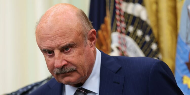 Dr. Phil McGraw looks on at an event in the Oval Office of the White House in Washington, DC on June 26, 2026.