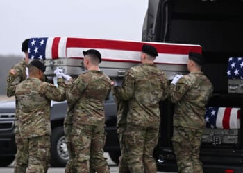 A U.S. Army carry team transports a flag-draped transfer case to a vehicle during a dignified transfer at Dover Air Force Base on March 7, 2026, in Dover, Delaware.