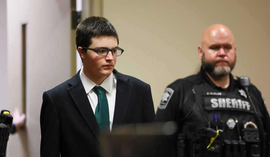 Colt Gray, the 16-year-old Apalachee High School shooting suspect, is led in by deputies for his sentencing at Barrow County Superior Court, Monday, July 27, 2026, in Winder, Ga. (Jason Getz/Atlanta Journal-Constitution via AP, Pool)